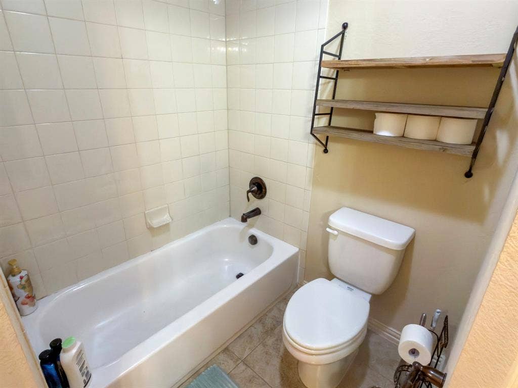 Tub and shower combination with white tile surround