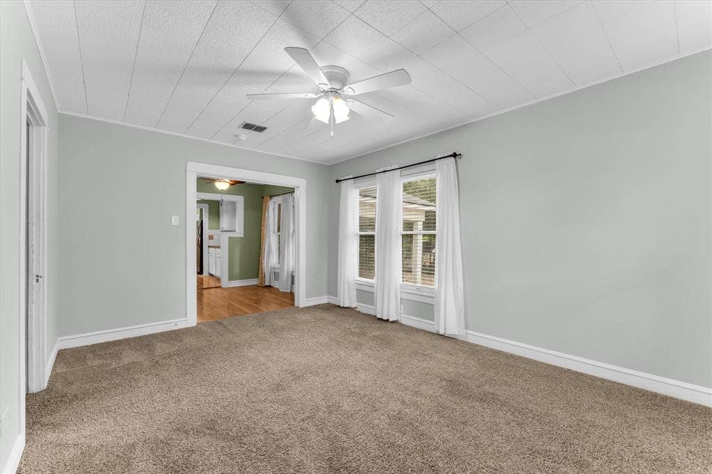 302 W Billington Drive, Robinson, TX 76706 Recessed ceiling with an overhead fan, dual windows, and carpeted flooring