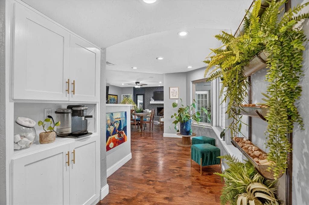 7016 Battle Creek Road, Fort Worth, TX 76116 Built-in cabinetry with gold-toned hardware, recessed lighting, wood-finish flooring, and a large interior window