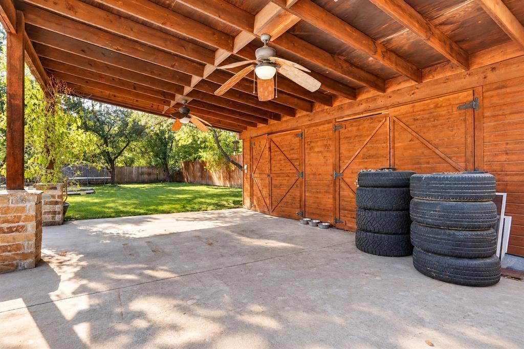 7016 Battle Creek Road, Fort Worth, TX 76116 Covered patio with concrete flooring, wood plank ceiling, and dual ceiling fans