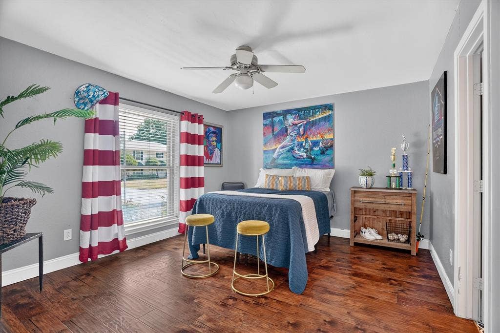 7016 Battle Creek Road, Fort Worth, TX 76116 Wood-finish flooring, ceiling fan light fixture, window with blinds, and light gray wall finish