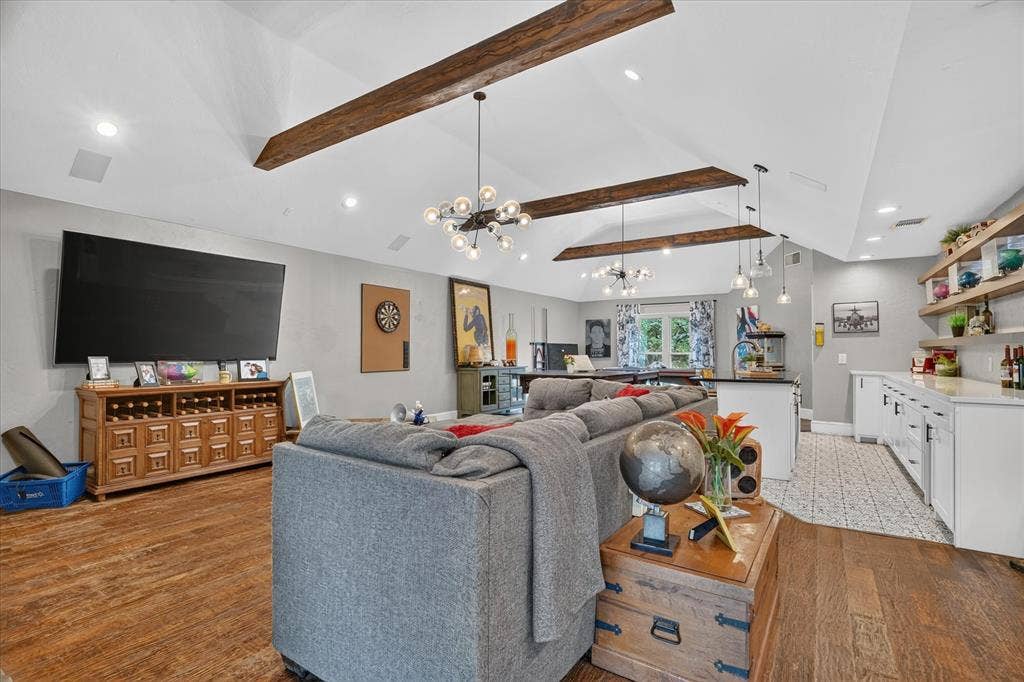 7016 Battle Creek Road, Fort Worth, TX 76116 Vaulted ceiling with exposed wood beams, wood-finish flooring, recessed lighting, built-in shelving, and white cabinetry with a light-toned countertop