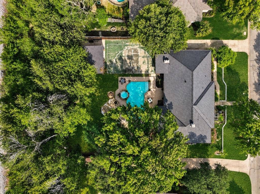 7016 Battle Creek Road, Fort Worth, TX 76116 Spacious property featuring a swimming pool, basketball court, and mature trees