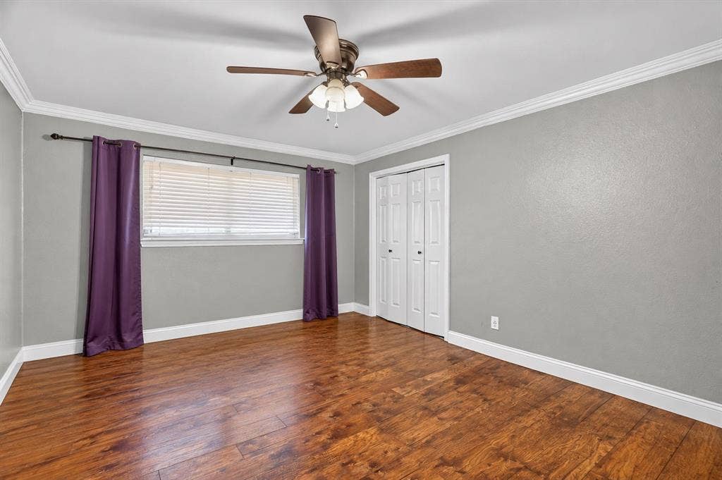 7016 Battle Creek Road, Fort Worth, TX 76116 Wood-finish flooring with white trim, a ceiling fan with integrated lighting, and a window with horizontal blinds