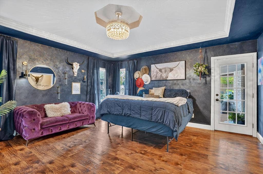 7016 Battle Creek Road, Fort Worth, TX 76116 Wood-finish flooring, crown molding, tray ceiling, crystal chandelier, and a multi-pane glass-panel door