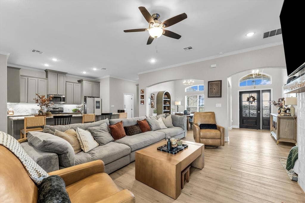 Open concept living space featuring wood-finish flooring, a ceiling fan, and recessed lighting