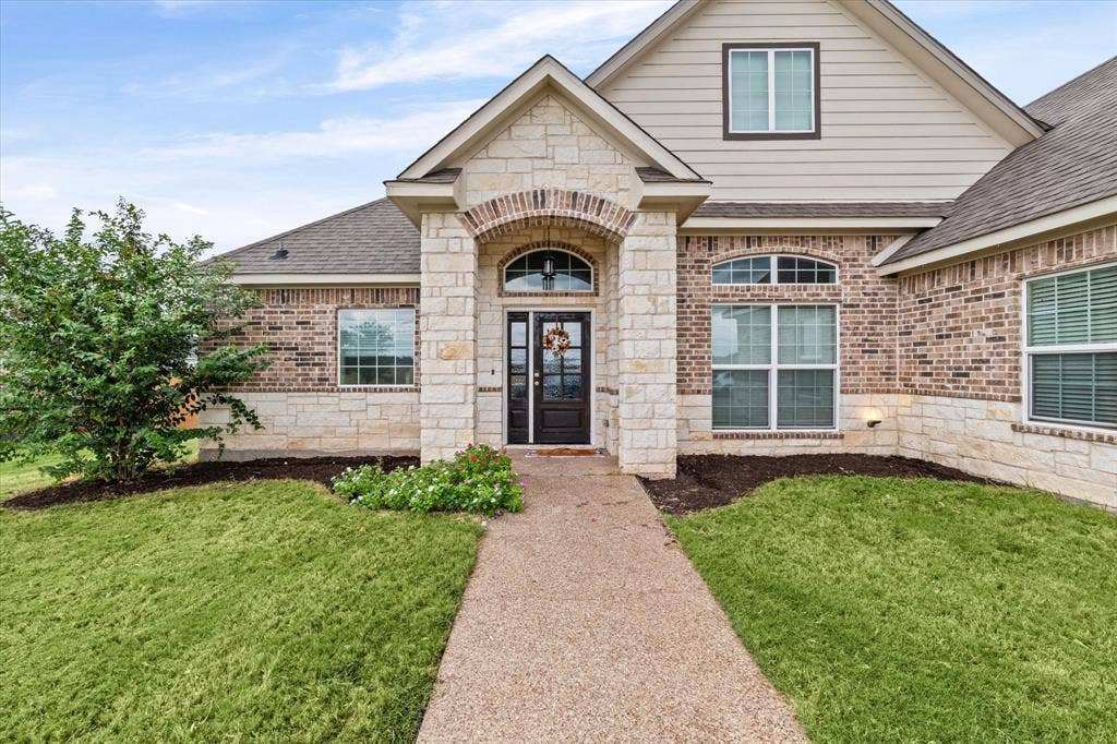 Brick and stone exterior with arched entryway