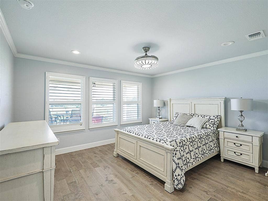 7470 Birmingham Forest Drive, Frisco, TX 75036 Primary Bedroom featuring LVP, Crown Molding and Shutters. Bedroom Furniture is negotiable with offer.