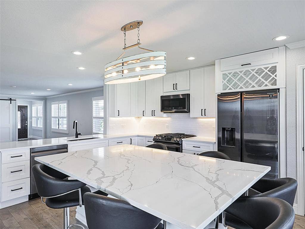 7470 Birmingham Forest Drive, Frisco, TX 75036 Upscale Lighting Fixtures and Wine Rack over refrigerator.