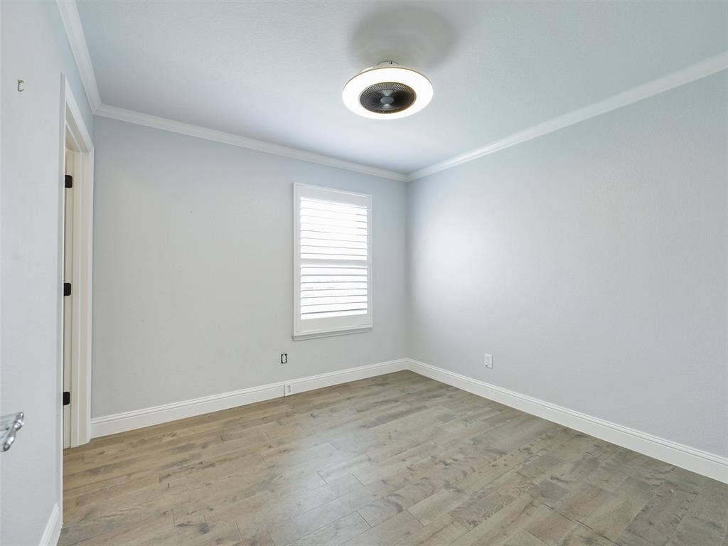 7470 Birmingham Forest Drive, Frisco, TX 75036 Second Bedroom room with updated lighting, LVP Flooring and crown molding