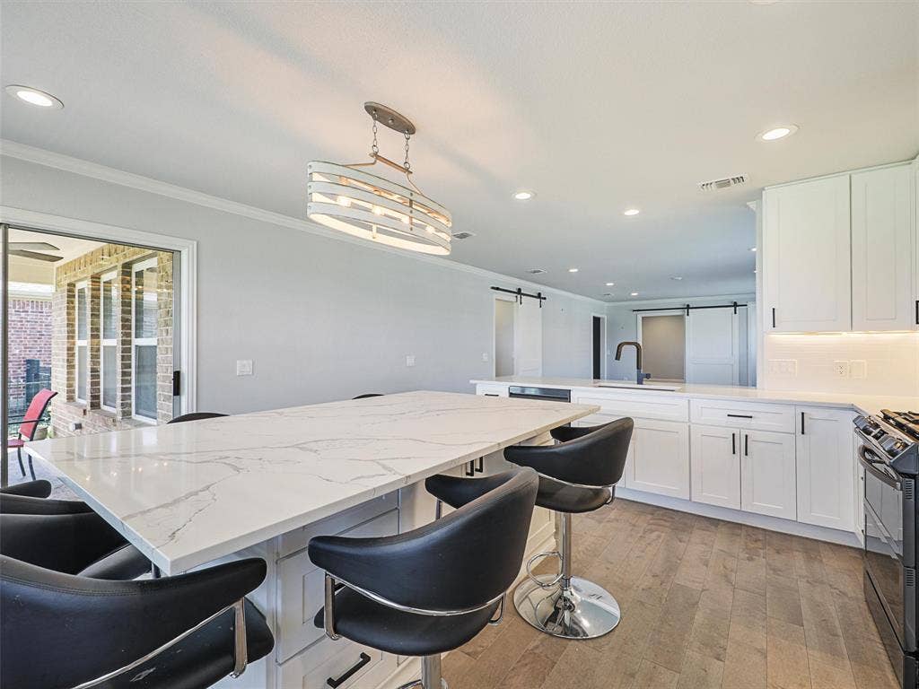 7470 Birmingham Forest Drive, Frisco, TX 75036 Kitchen has plenty of storage underneath Kitchen Island. Kitchen Island a great place to play games too!