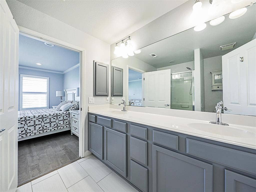 7470 Birmingham Forest Drive, Frisco, TX 75036 Bathroom with ornamental molding, an enclosed shower, and double sink vanity