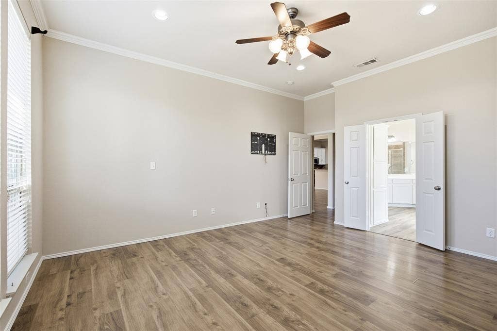 750 Village Green Drive, DeSoto, TX 75115 Vaulted ceilings, wood-finish flooring, ceiling fan with integrated lighting, recessed lighting, and white trim