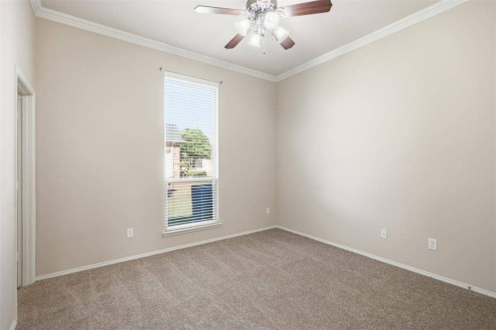 750 Village Green Drive, DeSoto, TX 75115 Carpeted flooring, crown molding, ceiling fan with light fixture, single window with blinds