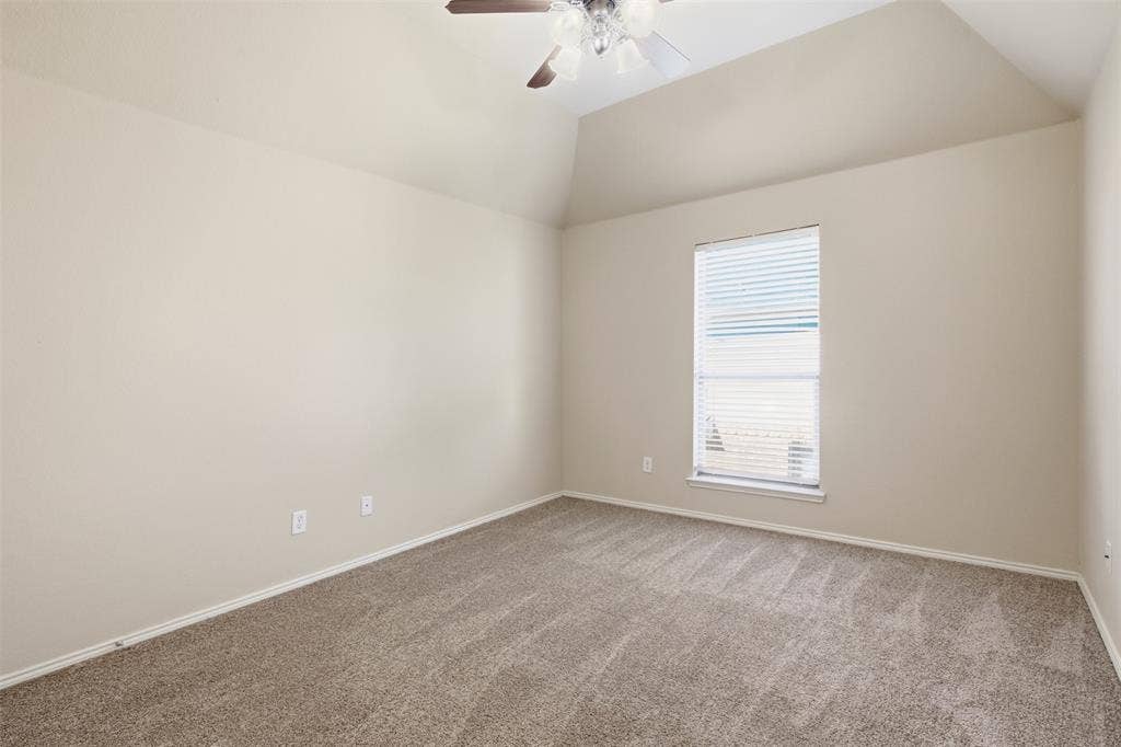 750 Village Green Drive, DeSoto, TX 75115 Vaulted ceiling with an attached ceiling fan, neutral tone carpeting, and a window with blinds