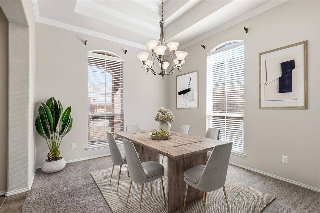 750 Village Green Drive, DeSoto, TX 75115 Tray ceiling with crown molding, arched window frames, chandelier lighting, and carpet flooring. Virtually staged