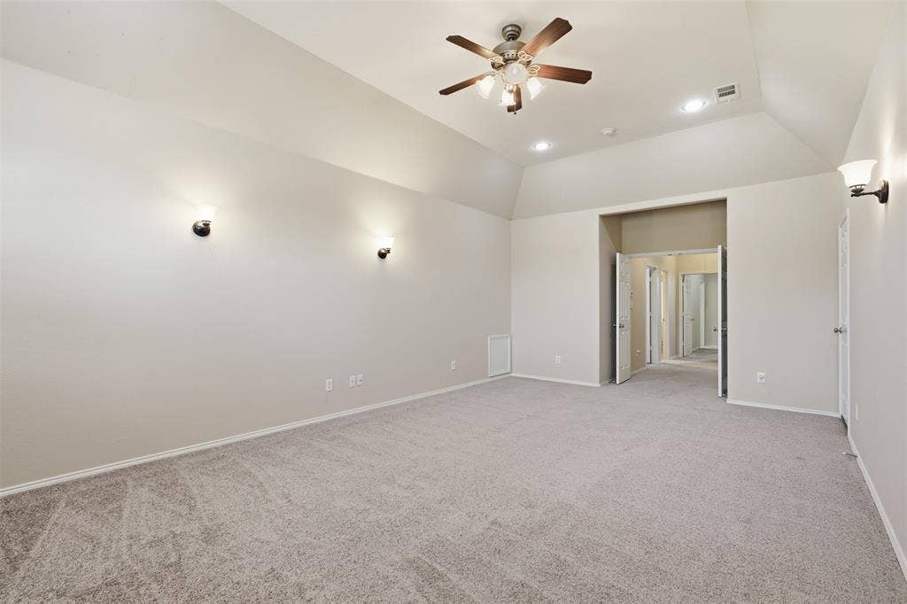 750 Village Green Drive, DeSoto, TX 75115 Vaulted ceiling with a ceiling fan, recessed lighting, and wall sconces