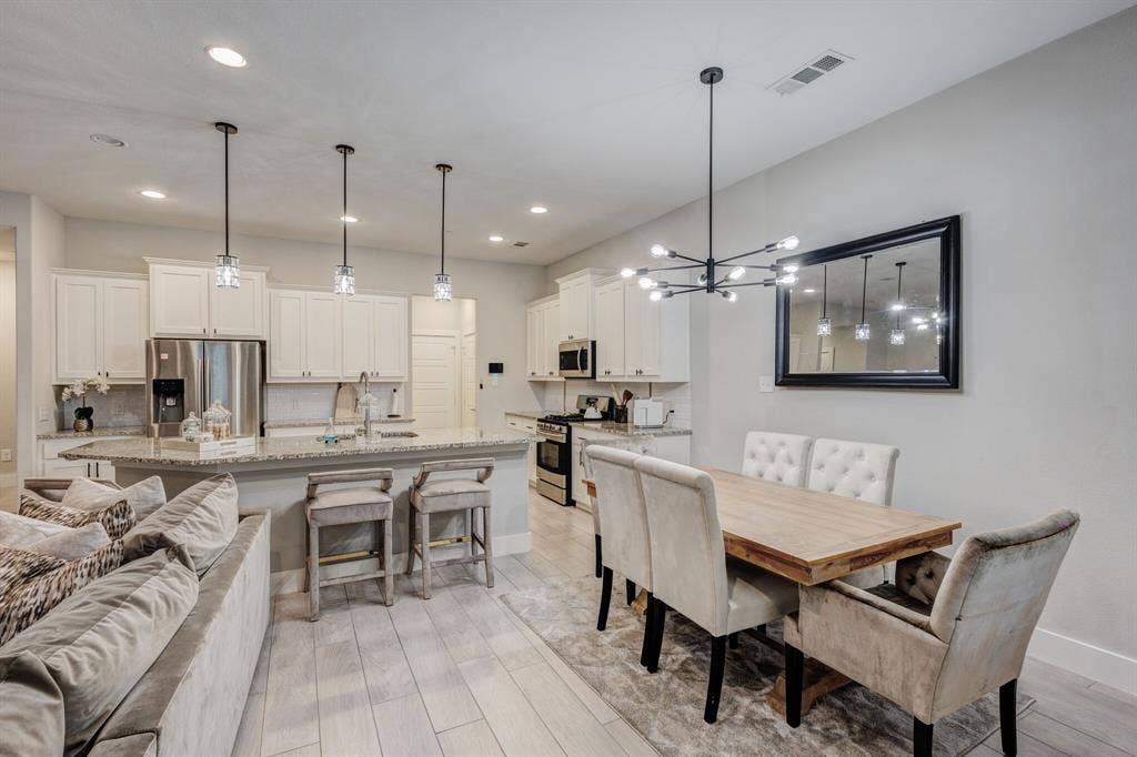 4814 Empire Way, Irving, TX 75038 Kitchen island with granite countertop and pendant lighting