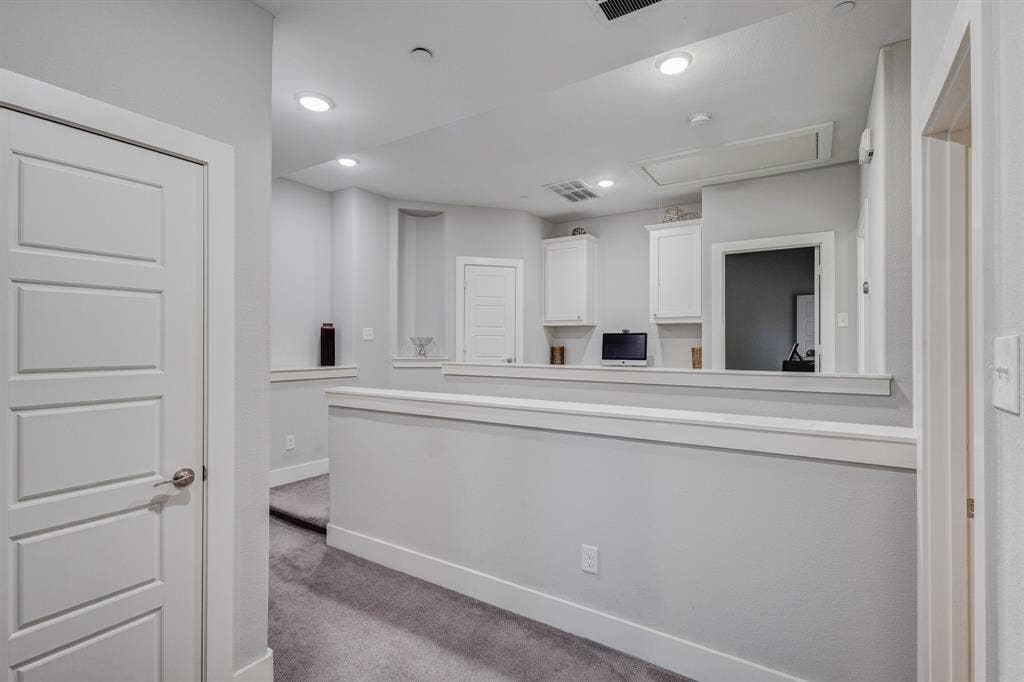 4814 Empire Way, Irving, TX 75038 Upper-level landing featuring recessed lighting, carpeted flooring, built-in cabinetry, and a half wall with a decorative ledge