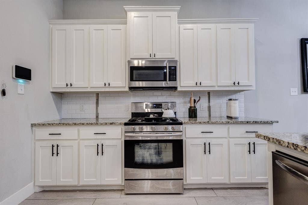 4814 Empire Way, Irving, TX 75038 Stainless steel range, microwave, and dishwasher