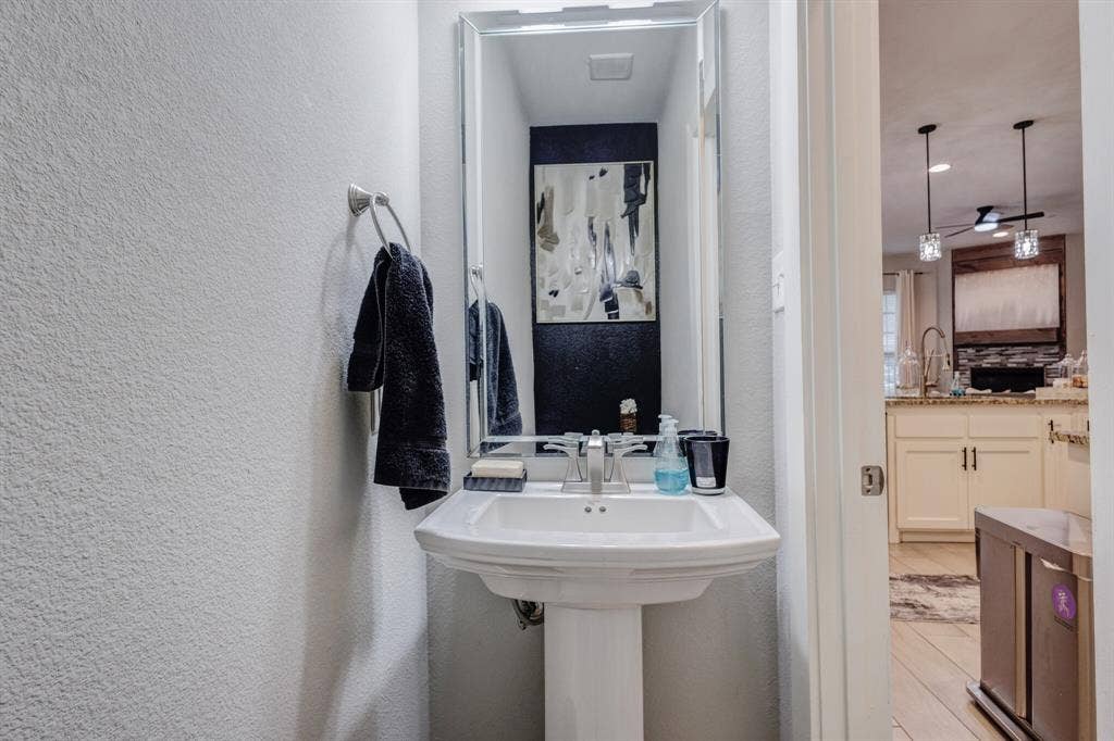 4814 Empire Way, Irving, TX 75038 Pedestal sink with a polished chrome faucet