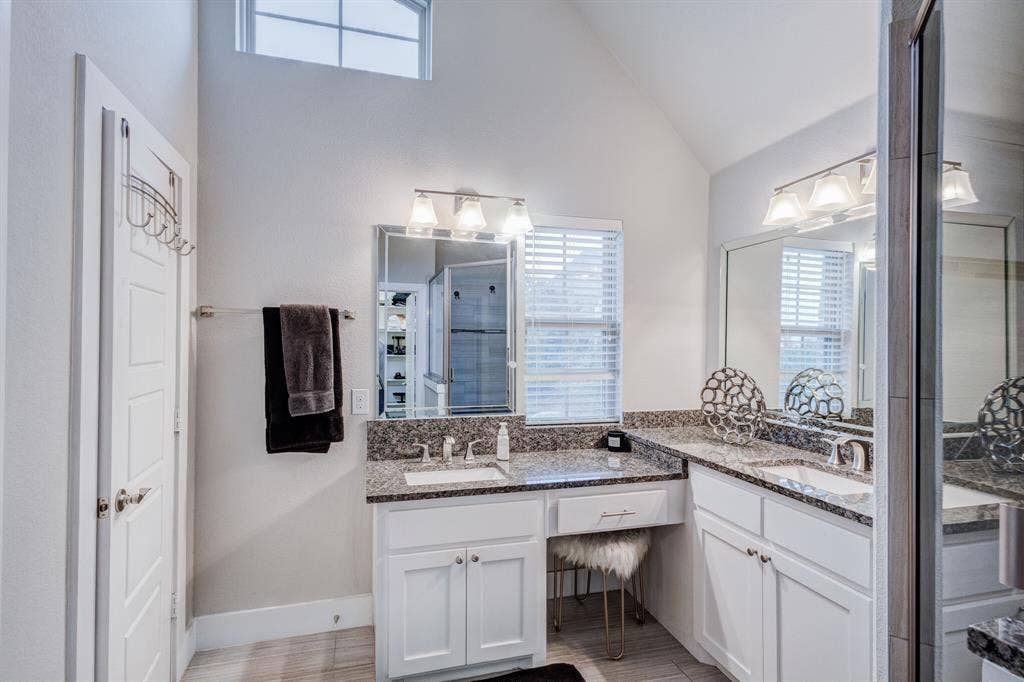 4814 Empire Way, Irving, TX 75038 Dual vanity with integrated sinks, granite countertops, and white cabinetry