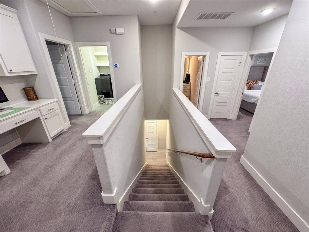 4814 Empire Way, Irving, TX 75038 Carpeted staircase and hallway with a built-in desk, paneled doors, and ceiling-mounted lighting