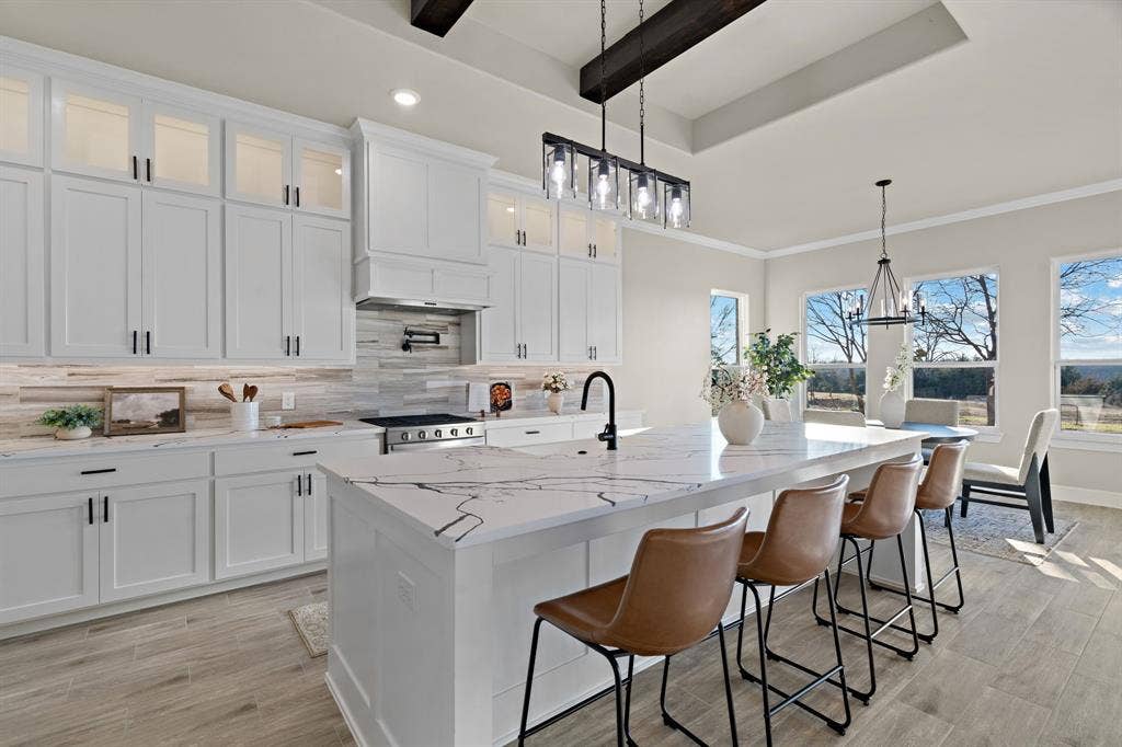 4205 County Road 570, Farmersville, TX 75442 Custom cabinets with decorative lighting up top. Quartz counter tops with a gas range stove for everyday cooking.