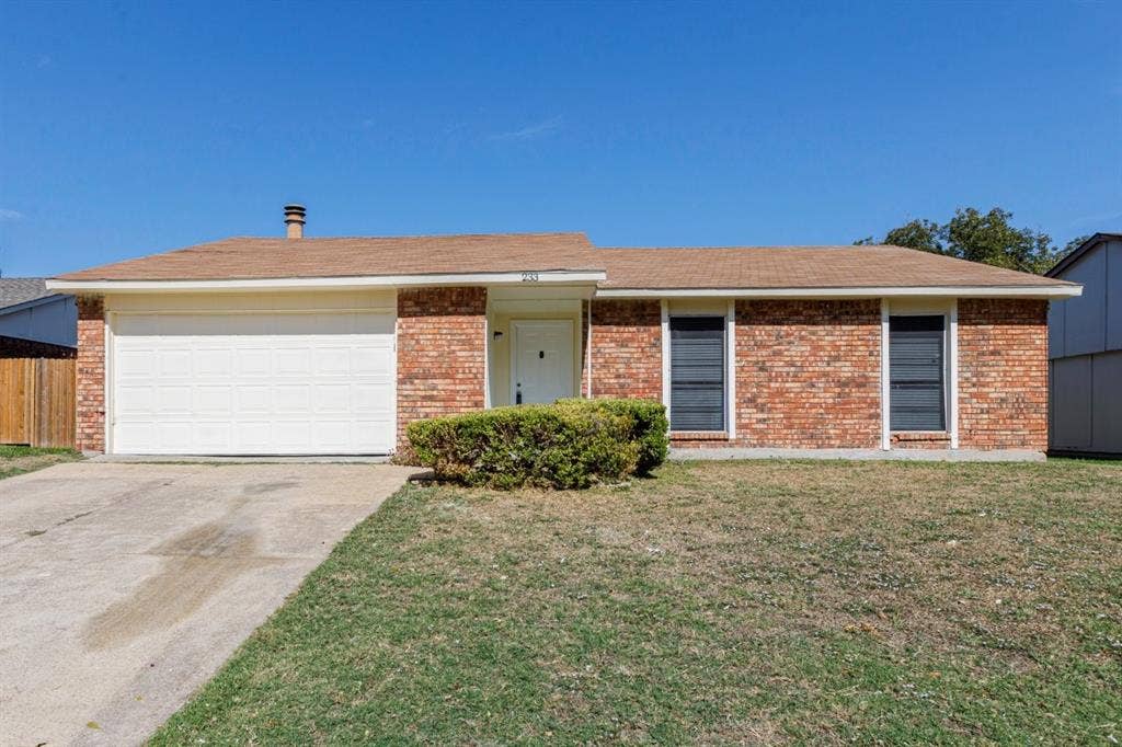 Welcome Home! Single-story exterior featuring a brick facade, attached two-car garage, and asphalt shingle roof
