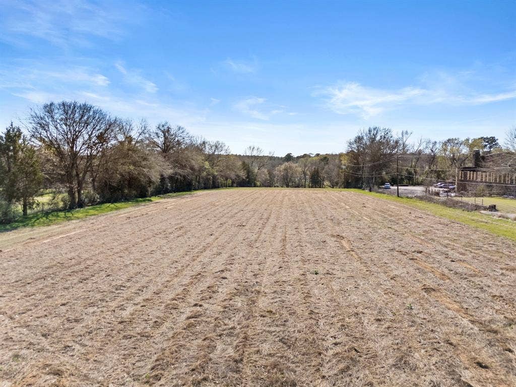 605 Dallas Street, Winona, TX 75792 Expansive open land with a clear, blue sky overhead