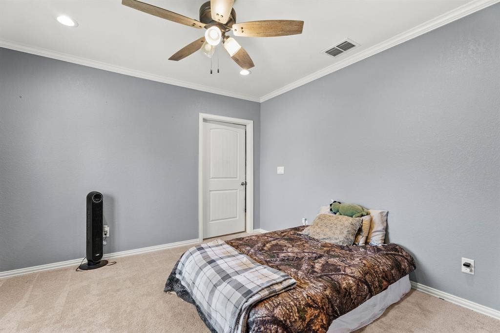 605 Dallas Street, Winona, TX 75792 Ceiling fan fixture, recessed lighting, crown molding, paneled interior door, and neutral-toned carpeting