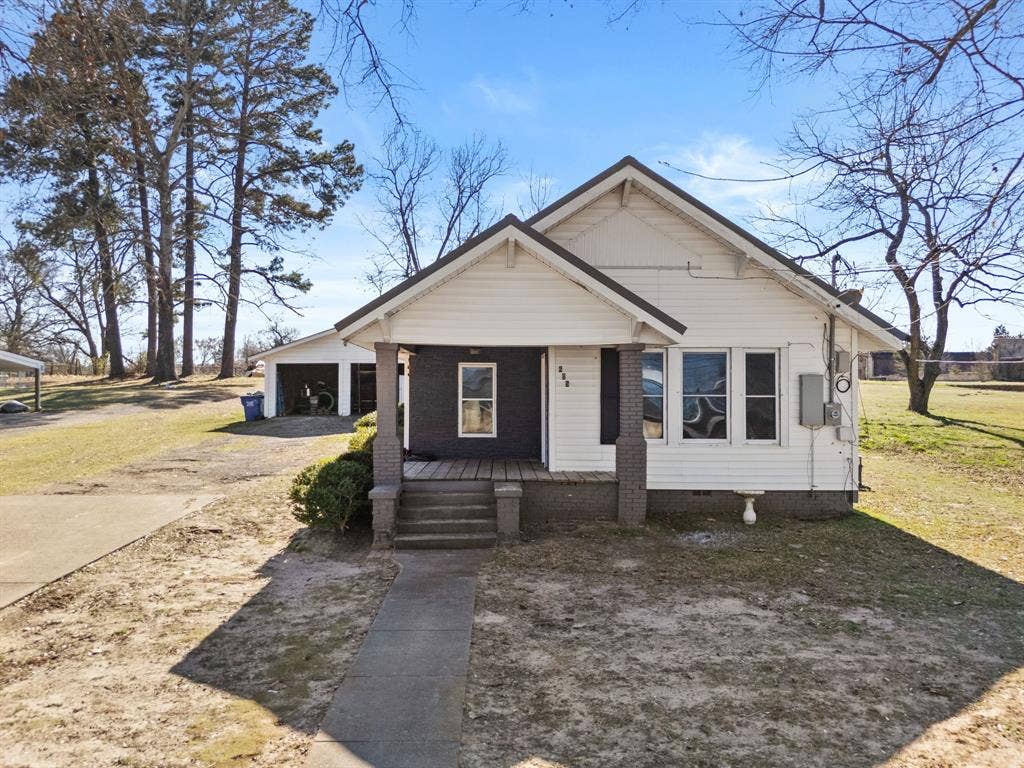 605 Dallas Street, Winona, TX 75792 Gabled-roof residence featuring white siding and dark brick accents
