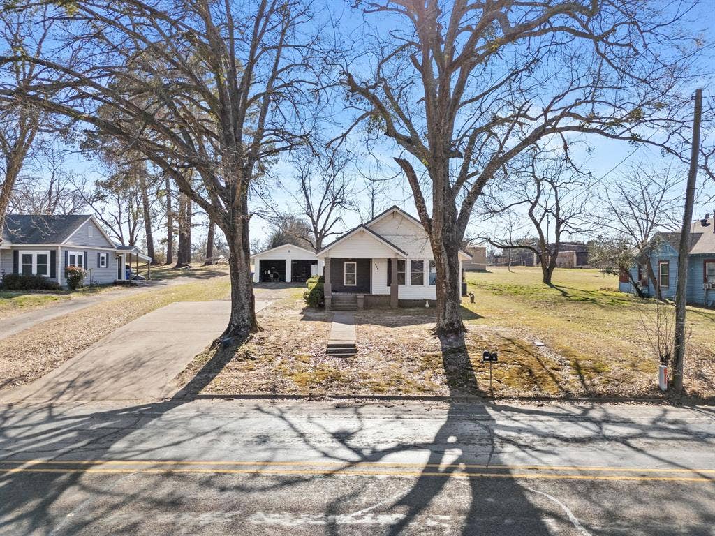 605 Dallas Street, Winona, TX 75792 Single-story residence with a covered front porch and a detached two-car garage