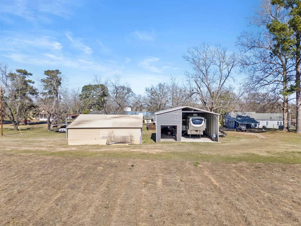 605 Dallas Street, Winona, TX 75792 Metal storage building, open-sided metal carport, and an additional dwelling