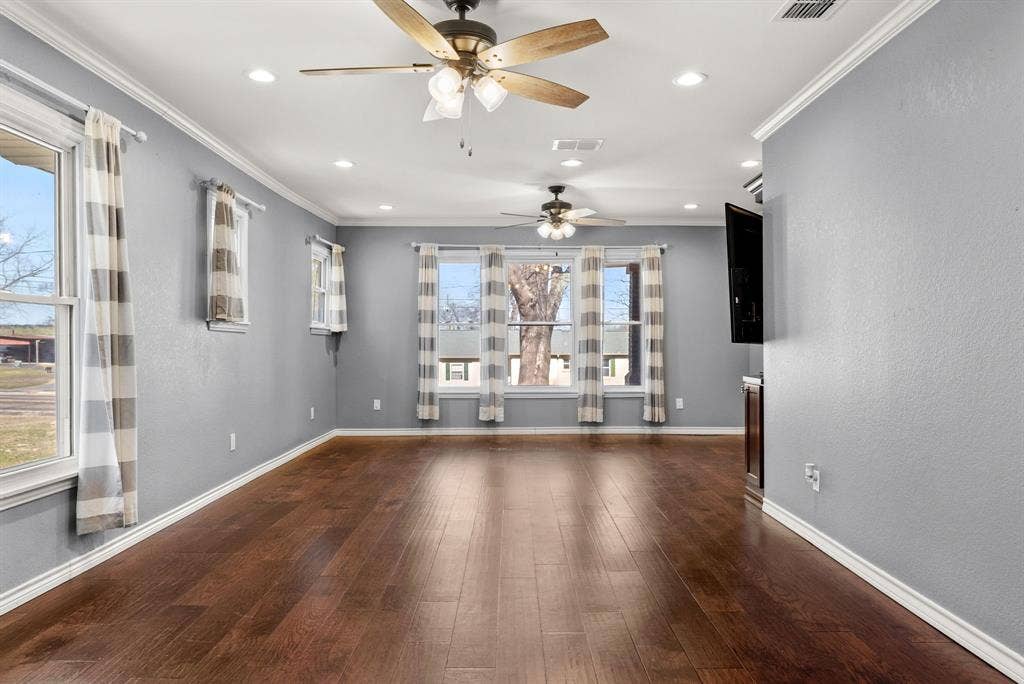 605 Dallas Street, Winona, TX 75792 Wood-finish flooring with light gray walls, recessed lighting, and multiple ceiling fans