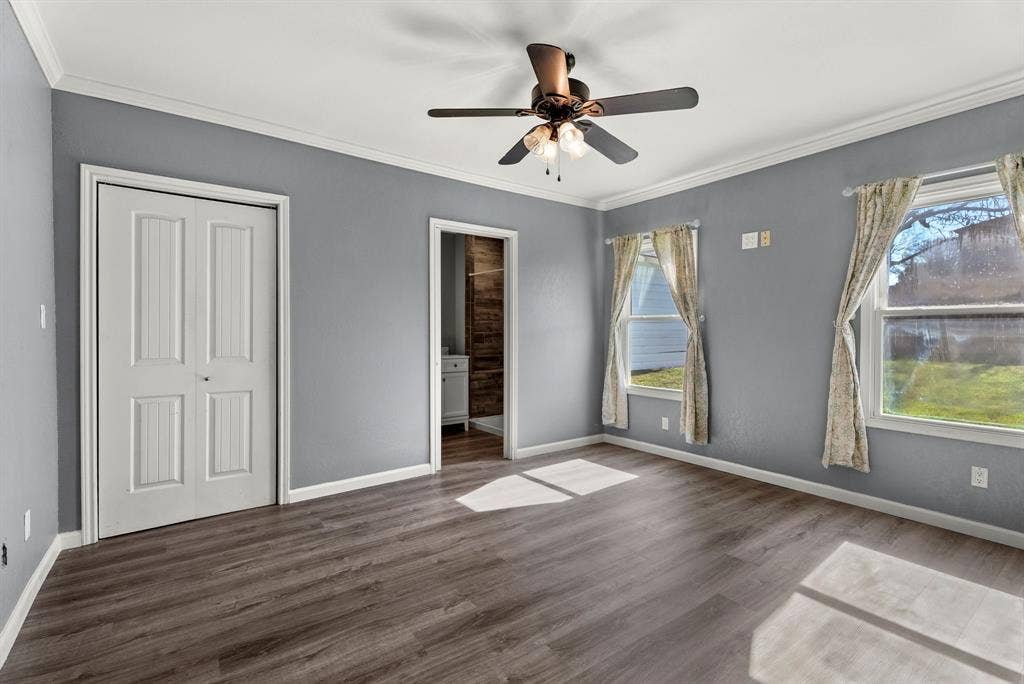 605 Dallas Street, Winona, TX 75792 Wood-finish flooring, ceiling fan with integrated lighting, two windows, and crown molding