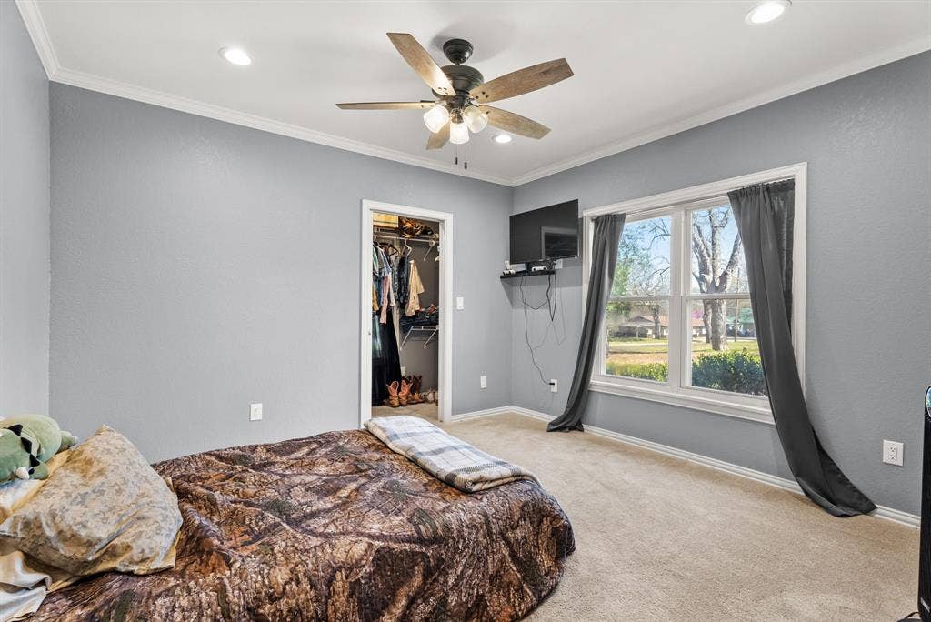 605 Dallas Street, Winona, TX 75792 Carpeted flooring, recessed lighting, ceiling fan with light fixture, window with exterior landscape, and a walk-in closet