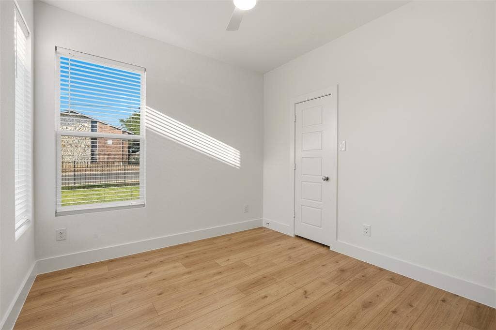 1601 Birdell Street, Fort Worth, TX 76105 Bright room featuring wood-finish flooring, white walls, and a multi-paneled door