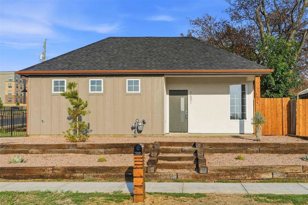 1601 Birdell Street, Fort Worth, TX 76105 Modern exterior with mixed siding and stucco, dark shingle roof, and wood-toned gutters