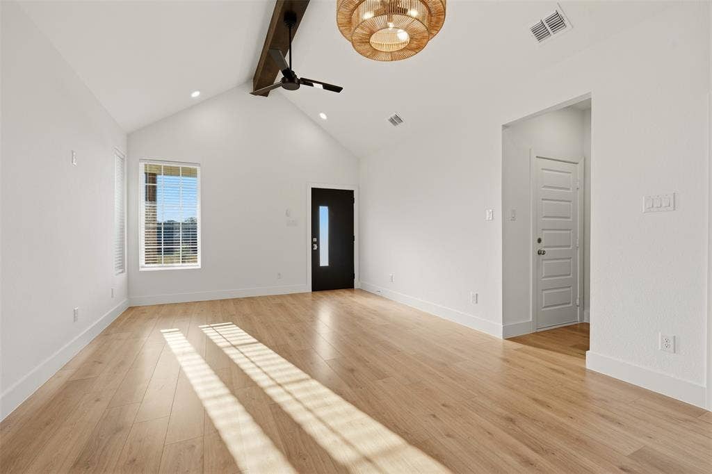 1601 Birdell Street, Fort Worth, TX 76105 Vaulted ceilings, wood-finish flooring, and a decorative ceiling fan with an exposed beam