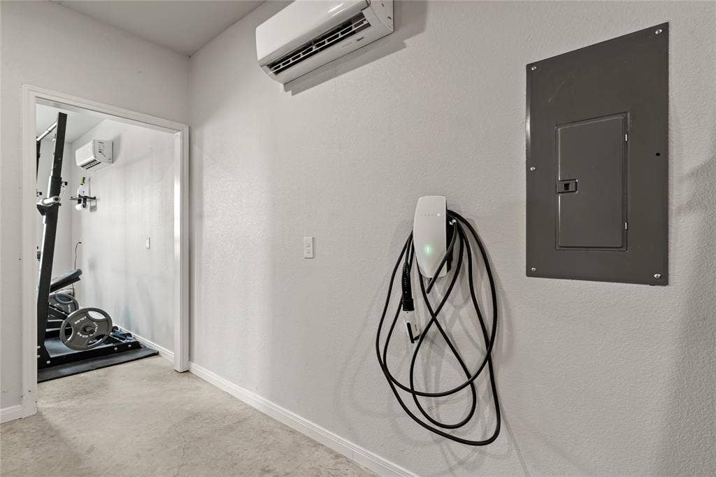 149 Water View Lane, Robinson, TX 76706 Wall-mounted electric vehicle charging station, split-system air conditioning unit, and electrical panel