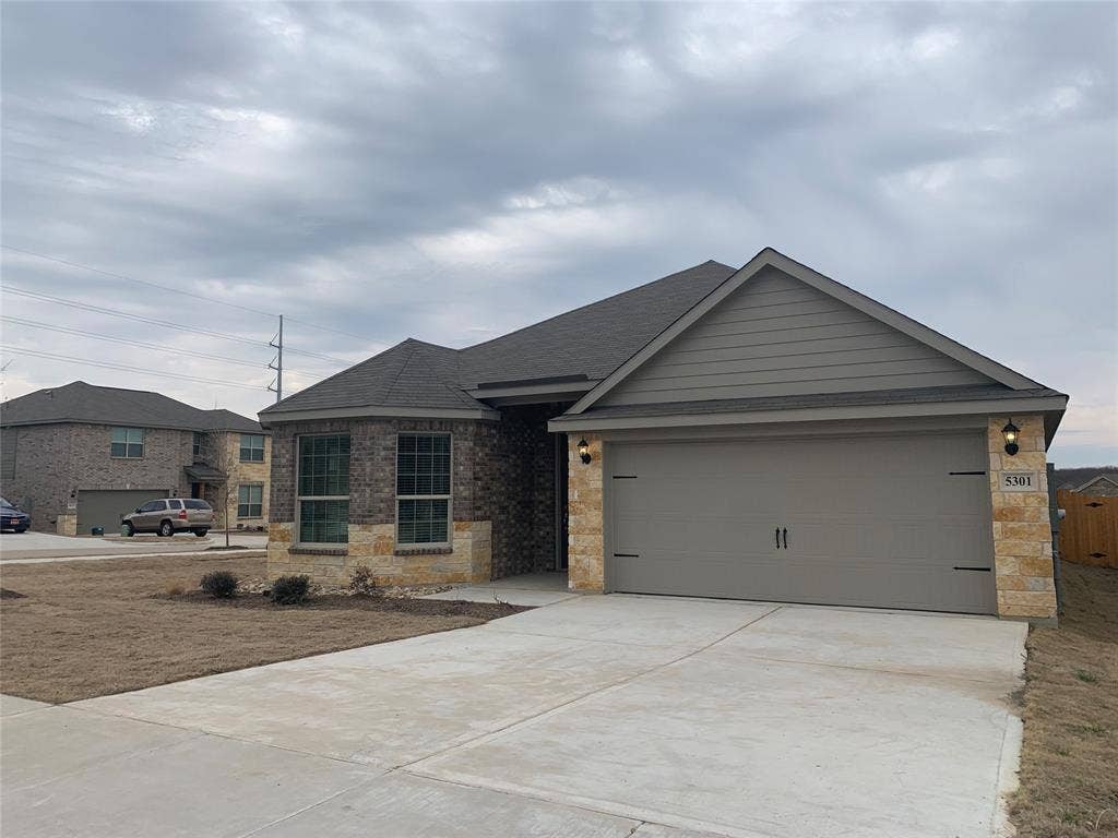 Stone and brick facade with a two-car garage