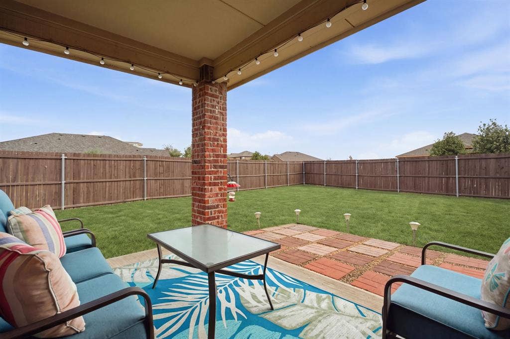 800 Amber Street, Princeton, TX 75407 Tranquil all year long on the covered patio. NE exposure means shade in the afternoon. For added ambiance, the seller is leaving the solar landscape lighting & string lights!