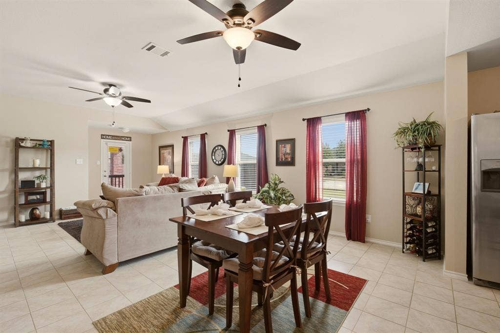800 Amber Street, Princeton, TX 75407 Picture windows add so much natural light + no neighbor beside this home to block the light either. Any table shape works well in this floating dining space.
