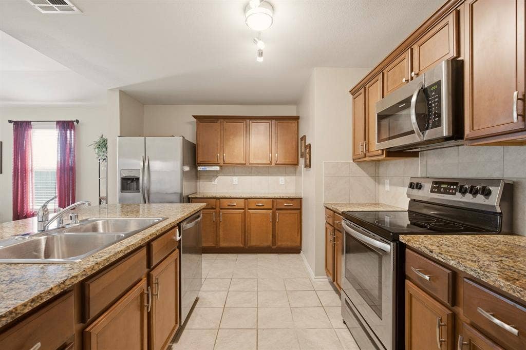 800 Amber Street, Princeton, TX 75407 Like to cook? You'll love the size of this very workable kitchen. All appliances convey, including the refrigerator, + it has awesome cabinet storage.