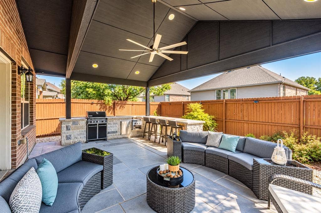 1704 Keswick Drive, McKinney, TX 75071 Covered patio with a built-in outdoor kitchen, recessed lighting, ceiling fan, and stone-accented bar