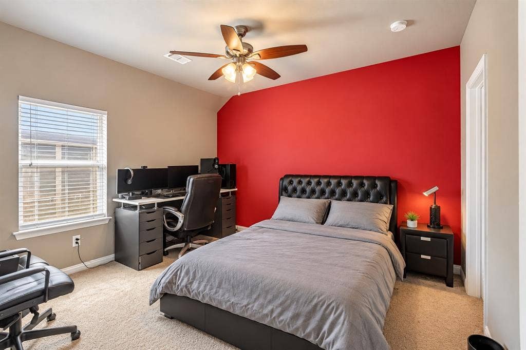 1704 Keswick Drive, McKinney, TX 75071 Carpeted room featuring a ceiling fan, window with blinds, and a two-tone wall treatment