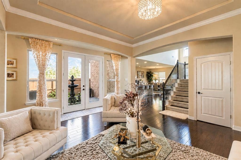 1704 Keswick Drive, McKinney, TX 75071 Hardwood-finish flooring, recessed tray ceiling, built-in staircase, French doors, and an arched entryway