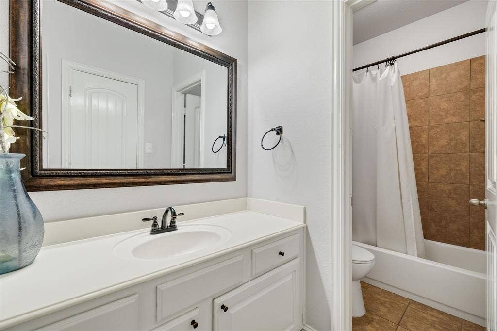 Located just outside of the downstairs bedroom is a full bath.