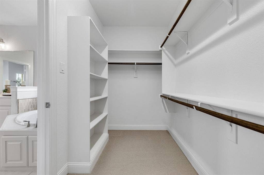 Built-in shelving, multiple hanging rods, and ample storage space